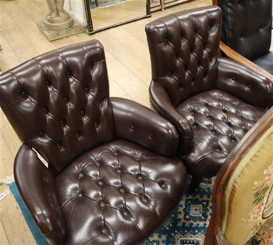 A pair of button leather tub armchairs